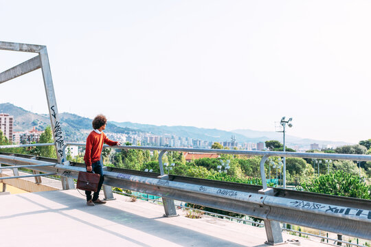 Black afro businessman standing on a Barcelona lookout.