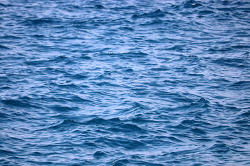 Water surface of deep blue sea. Soft waves texture, ripple water for background