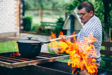Mature man preparing food on bbq