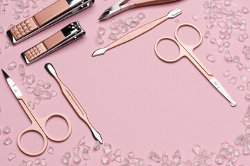 Fototapeta na wymiar Tools of a manicure set on a pink background. Copy space for text. Top view