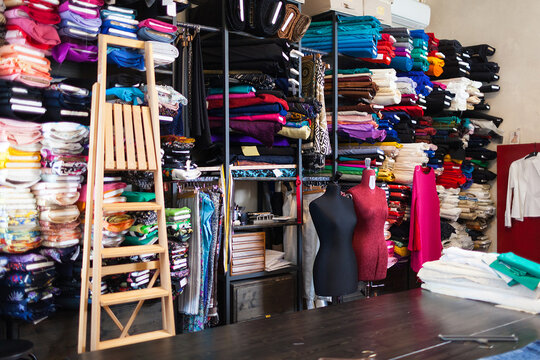 Wall Background Full of Fabric . Dressmaker Shop