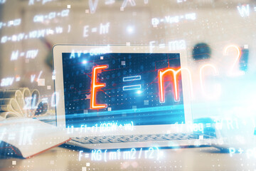 Desktop computer background and formula hologram writing. Double exposure. Education concept.