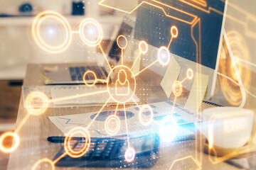 Computer on desktop with social network hologram. Multi exposure. Concept of international people connections.