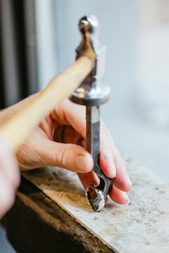 Jewellery designer stamping logo onto wedding ring