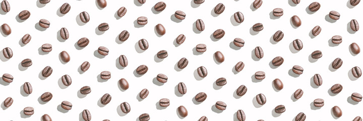Many coffee beans at white background. Isolated pattern seeds. Roast arabica restaurant concept. Taste energy brown morning beverage. Cafe wallpaper. Horizontal banner. Hard shadows