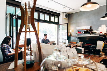 Two Customers Reading in Modern CafÔøΩÔøΩ
