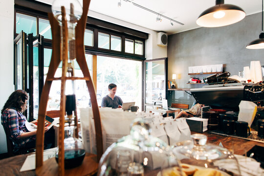 Two Customers Reading in Modern Caf&Ocirc;&oslash;&Omega;&Ocirc;&oslash;&Omega;