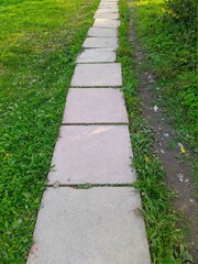 path in the park is made of concrete square slabs
