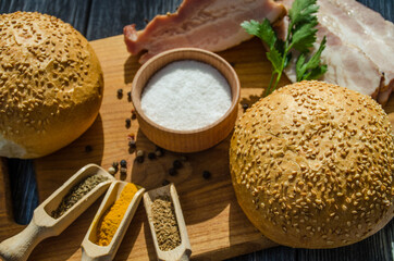 Still life with pieces of bacon on the wooden background