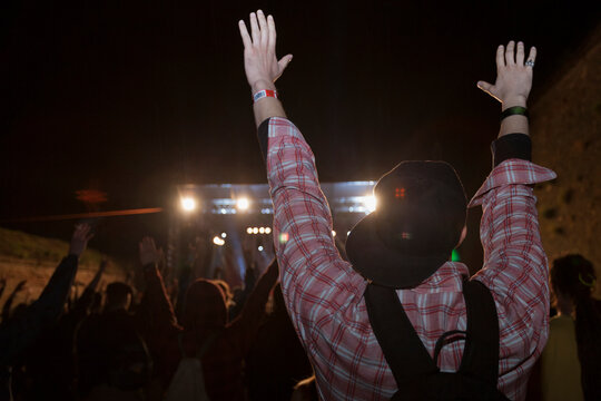 Man having his hands up in the air at music festival