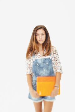 Portrait of a young teenager girl with notebook