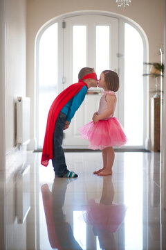 superhero boy and ballerina girl kissing