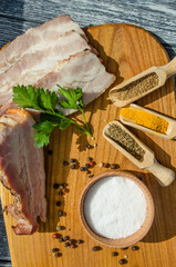 Still life with pieces of bacon on the wooden background