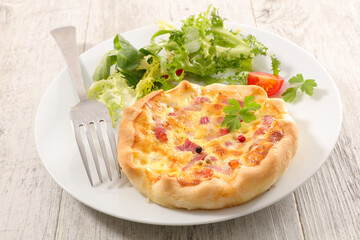 quiche lorraine and lettuce on plate