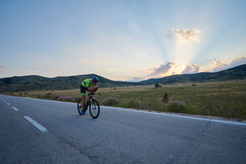Obraz na płótnie Canvas triathlon athlete riding bike