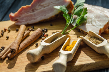 Still life with pieces of bacon on the wooden background
