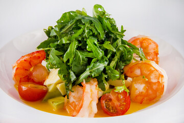 Salad with king prawns, arugula, tomatoes, avocado.