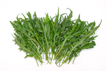 Rucola. Bunch of fresh green arugula leaves on a white background. Place for your text.