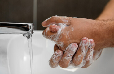 Fototapeta premium Coronavirus pandemic prevention wash hands with soap