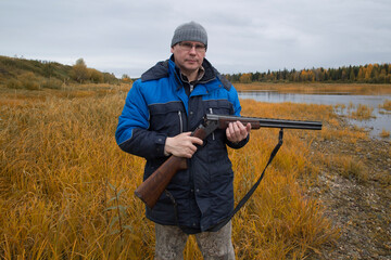 Hunter with a gun . Autumn duck hunting.