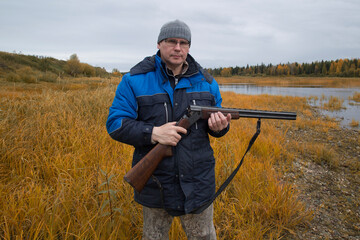 Fototapeta premium Hunter with a gun . Autumn duck hunting.