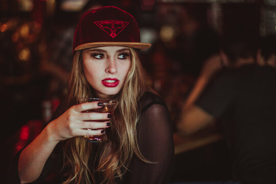 Beautiful Woman drinking alone in a beatnik lounge in San Francisco