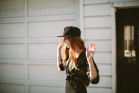 Young woman throws her hands in the air