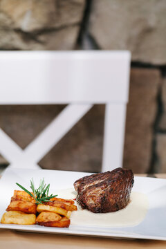 Grilled strip steak with bearnaise sauce and potato wedges