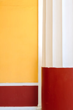 Red and white stone pillar against a red and yellow background