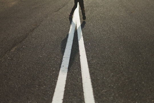 Girl jumping over converging lines
