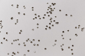 Silver sequins on pastel background. Christmas or birthday backdrop.