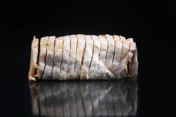 raw tempeh on a glass base and black background