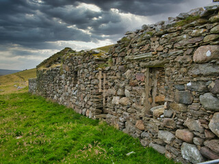 With threatening grey skies, an abandoned, derelict croft / farm house island of Yell in Shetland, Scotland, UK © Alan