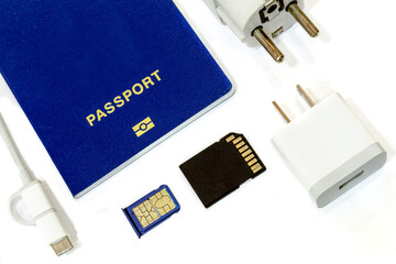 Travel concept in a still life high key photo. Blue bio-metric passport with sim card, memory card,...