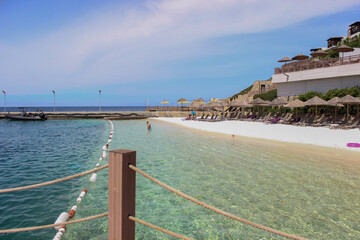 Sandy beach with emerald sea water