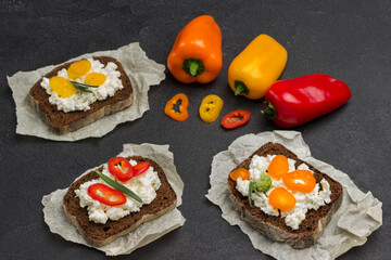 Variety of small sandwiches with various toppings. Colored pepper.