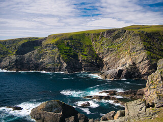 Steeply inclined eroded rock strata on Funzie Ness on the island of Fetlar in Shetland, Scotland,...