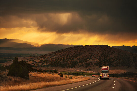 Semi-truck driving in beautiful mountain scene