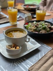 Carrot cream soup with vegan salad, vertical image