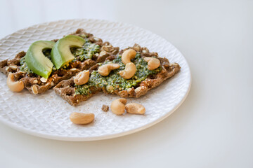 two crackers with pesto on breakfast