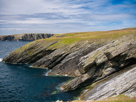 Steeply inclined eroded rock strata on Funzie Ness on the island of Fetlar in Shetland, Scotland, UK - Rocks in this area are of the Muness Phyllites Formation - Metaconglomerate - metamorphic bedrock