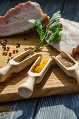 Still life with pieces of bacon on the wooden background