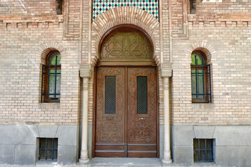 Classical doors on brick wall downtown of Madrid, Spain. Elegant entrance to the house from outside