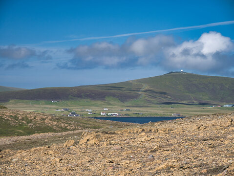 Deposits of serpentine rock at the Keen of Hamar Nature Reserve near Baltasound on the island of Unst, Shetland, UK. The white  dome of the RAF Saxa Vord remote radar head can be seen in the distance.
