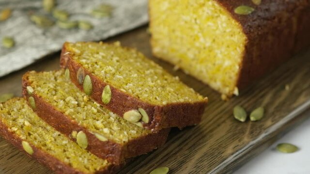 Gluten Free Pumpkin bread loaf set on white cafe table.