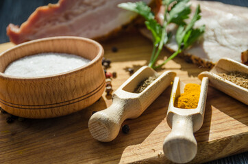 Still life with pieces of bacon on the wooden background