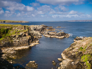 Obraz premium Dramatic coastal scenery showing inclined and eroded rock strata around the Ness of Queyon, near Otters Wick on the island of Yell in Shetland, Scotland, UK - metamorphic bedrock
