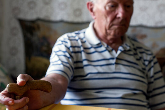 Distraught Old Man Holding A Crutch