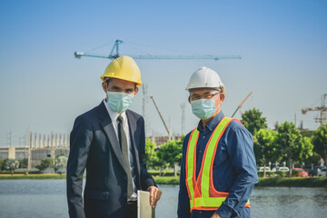 Two people Businessman talking with senior on site construction about real estate plant project and Business project