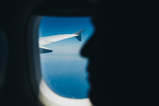 Face silhouette and airplane wing